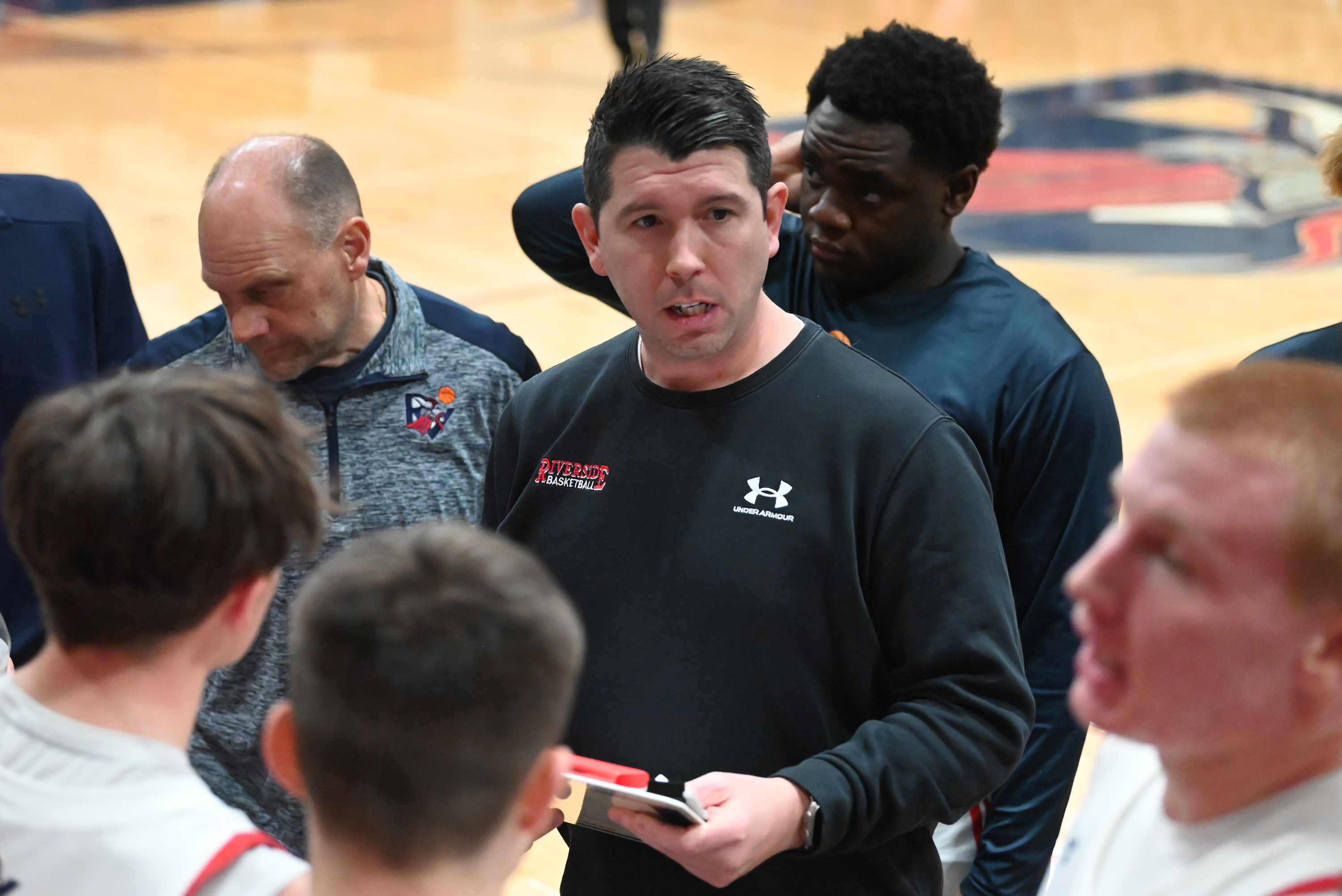 Riverside’s head coach Josh Aniska talks to his players during...