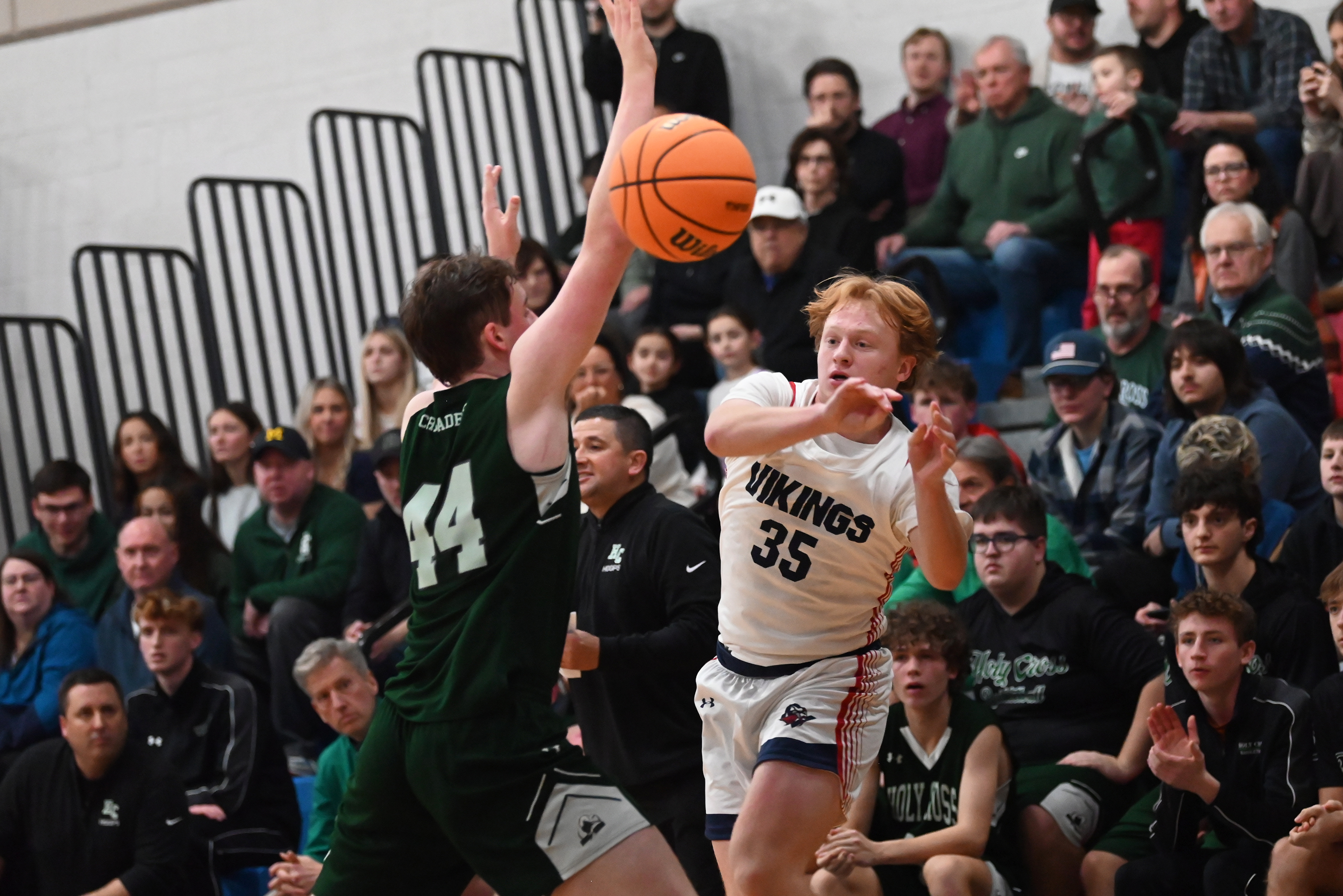 Riverside’s Max Jackson passes the ball around Holy Cross’ Colin...