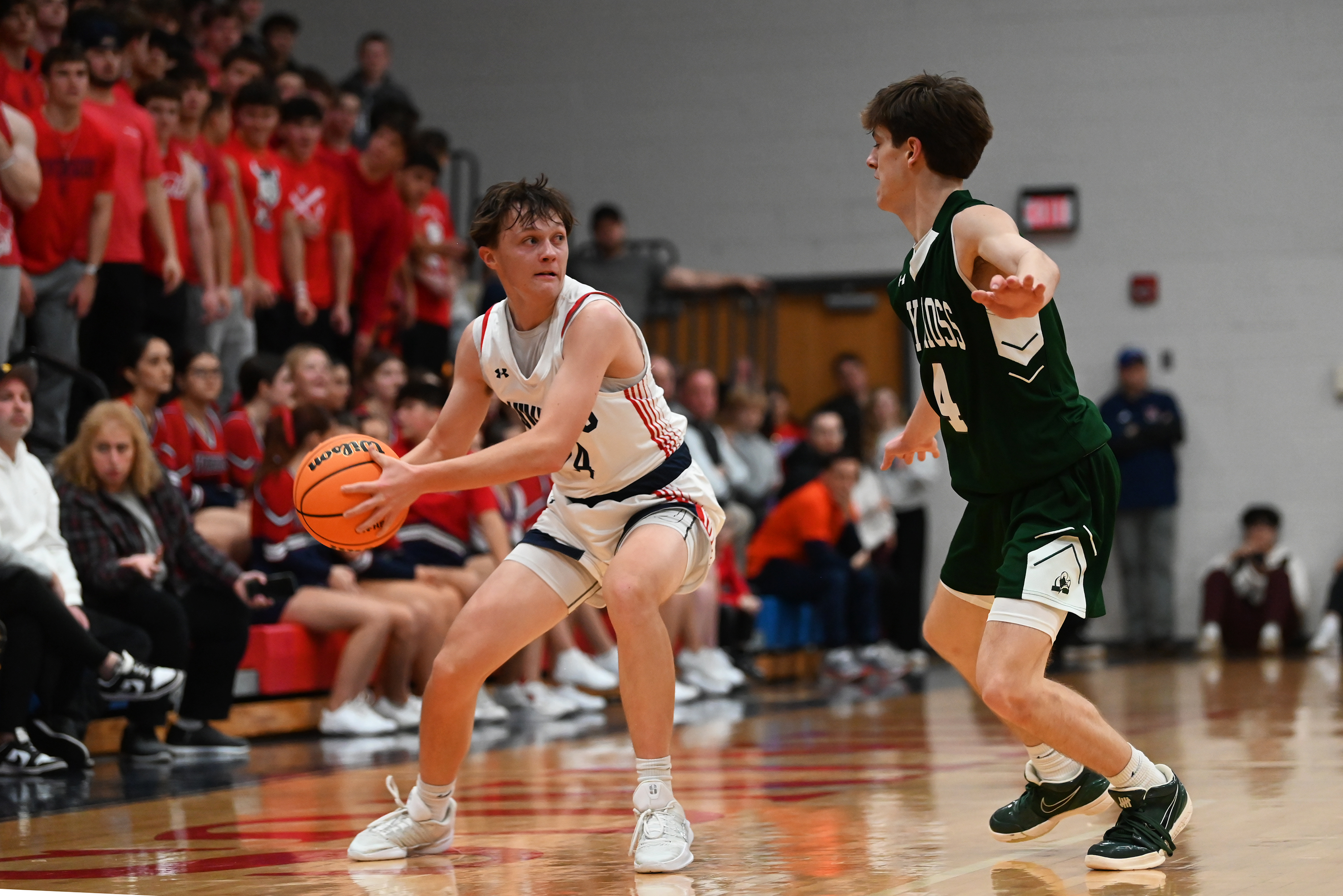 Holy Cross’ Colin Ritterbusch guards Riverside’s Kyle Connor during the...