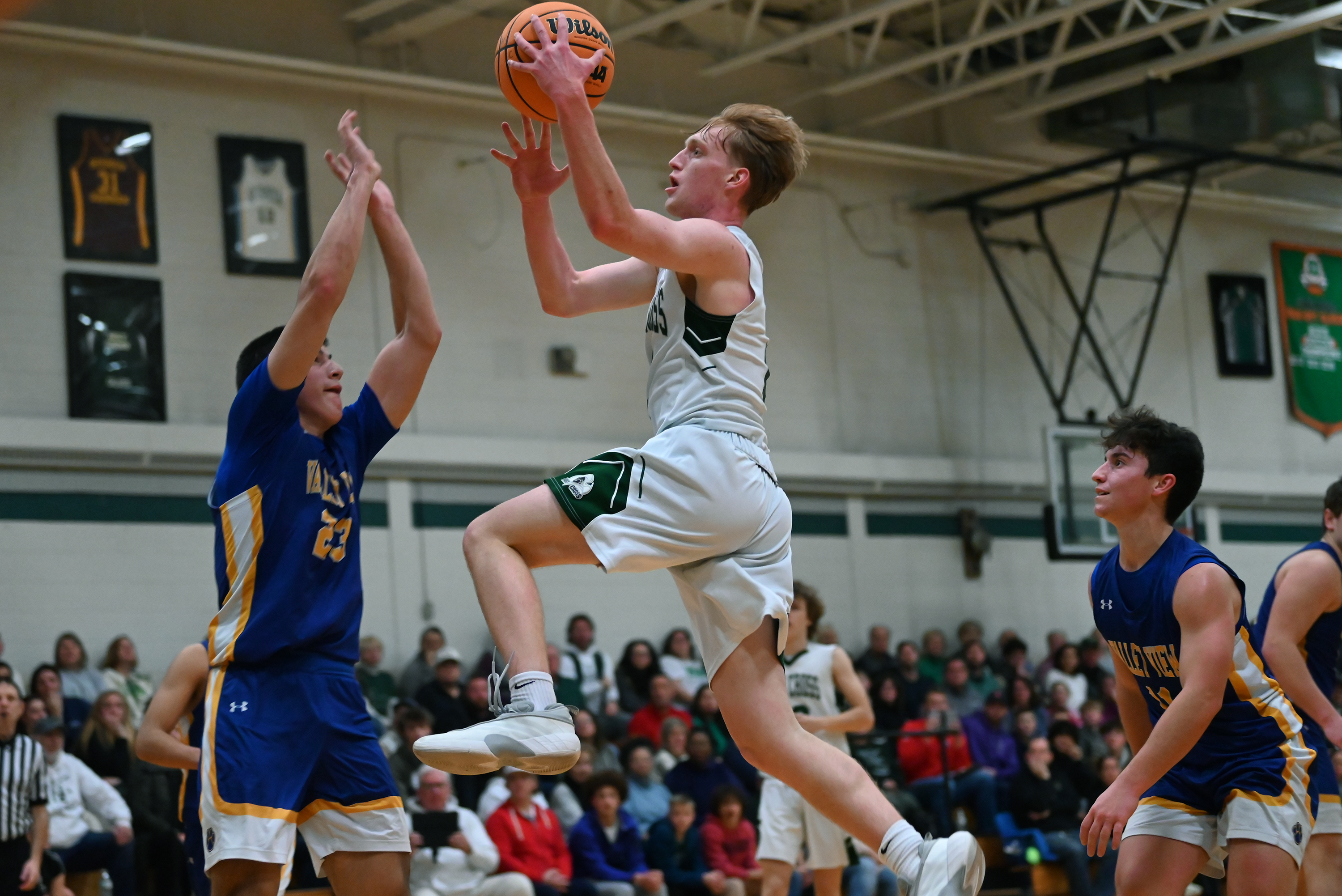 Holy Cross’ Adam Badyrka leaps for the hoop during the...
