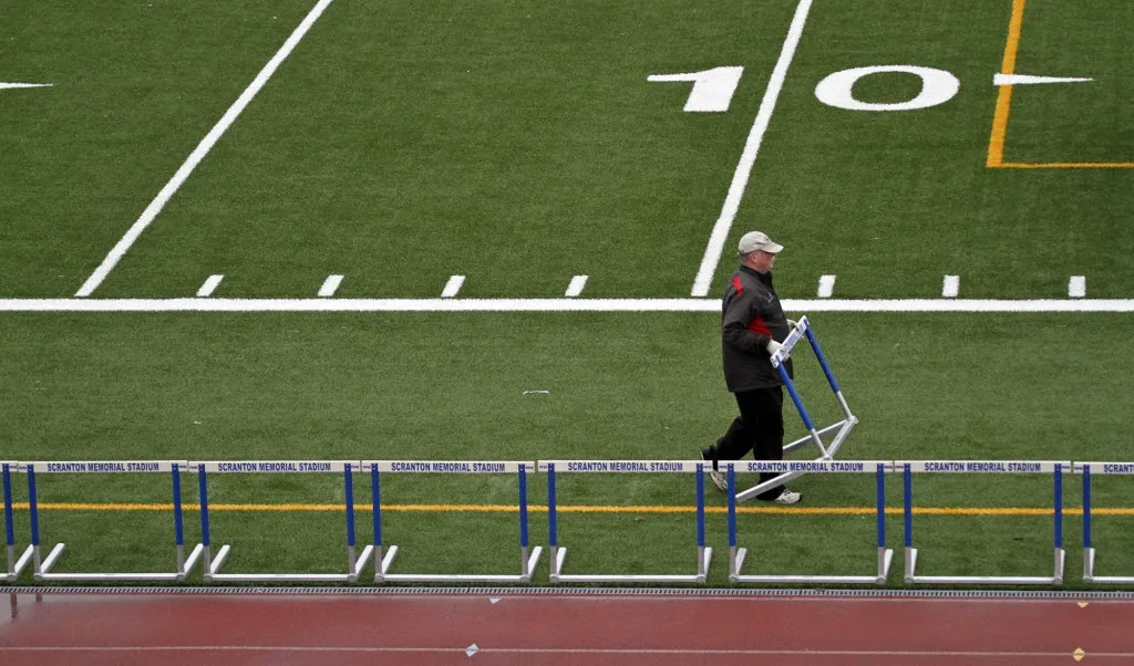 Steamtown Marathon co-founder Jim Moran sets up a finish line...