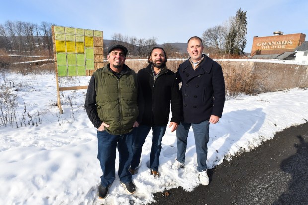 Business partners Nick Belfiore Adam Guiffrida and John Wilkens pose for a photograph at the future site of their future development, the Studebaker Lofts, in Olyphant Tuesday, December 16, 2025. (SEAN MCKEAG / STAFF PHOTOGRAPHER)
