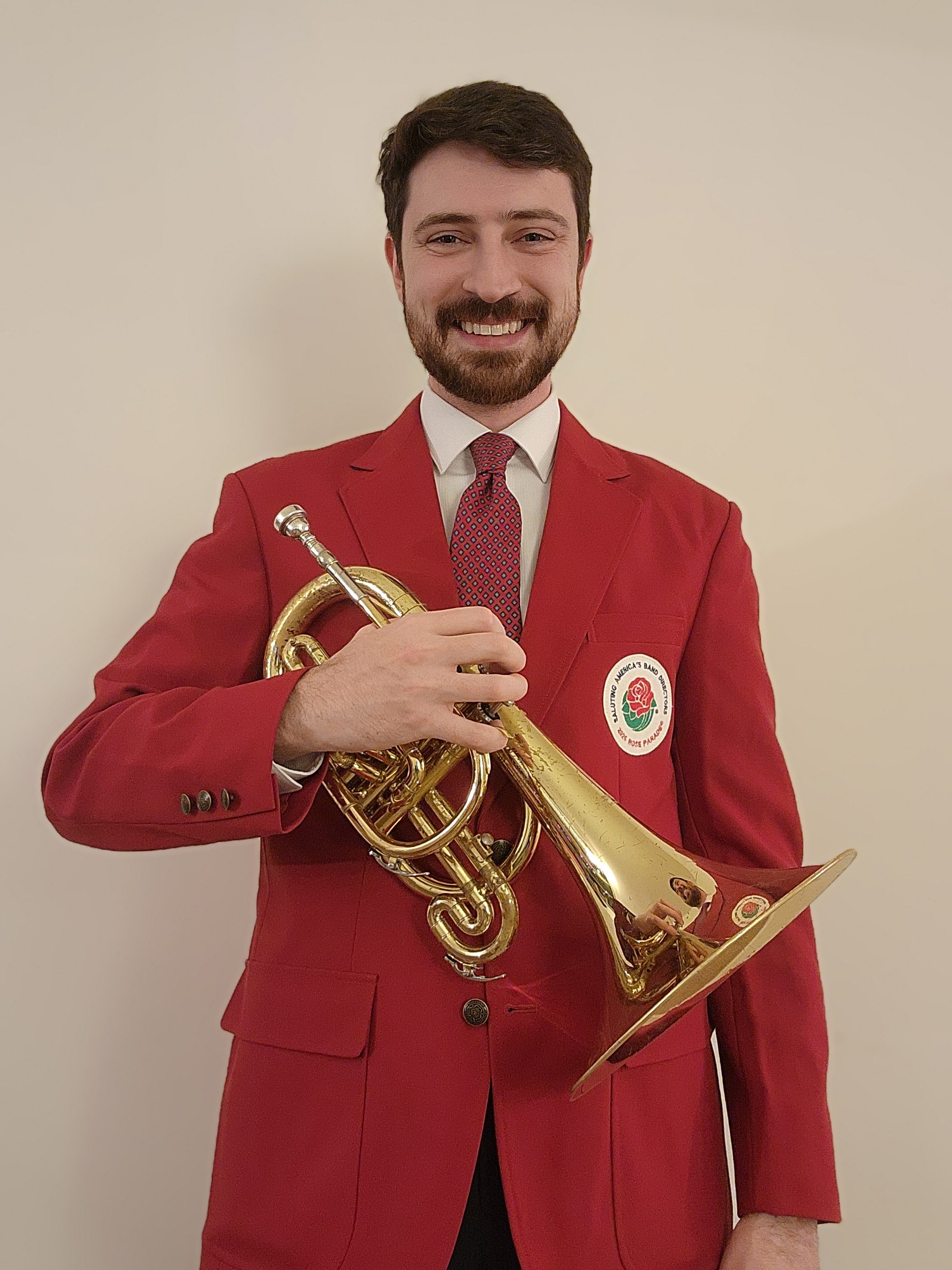 Andrew Gallagher poses in his uniform and with his mellophone...