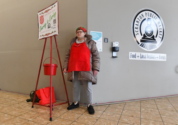 Volunteer with The Salvation Army and consumer with the Arc of Northeastern Pennsylvania Amanda Lewis, of Dickson City, rings her bell for donations at the entrance of The Marketplace at Steamtown in Scranton Thursday, December 4, 2025. (SEAN MCKEAG / STAFF PHOTOGRAPHER)
