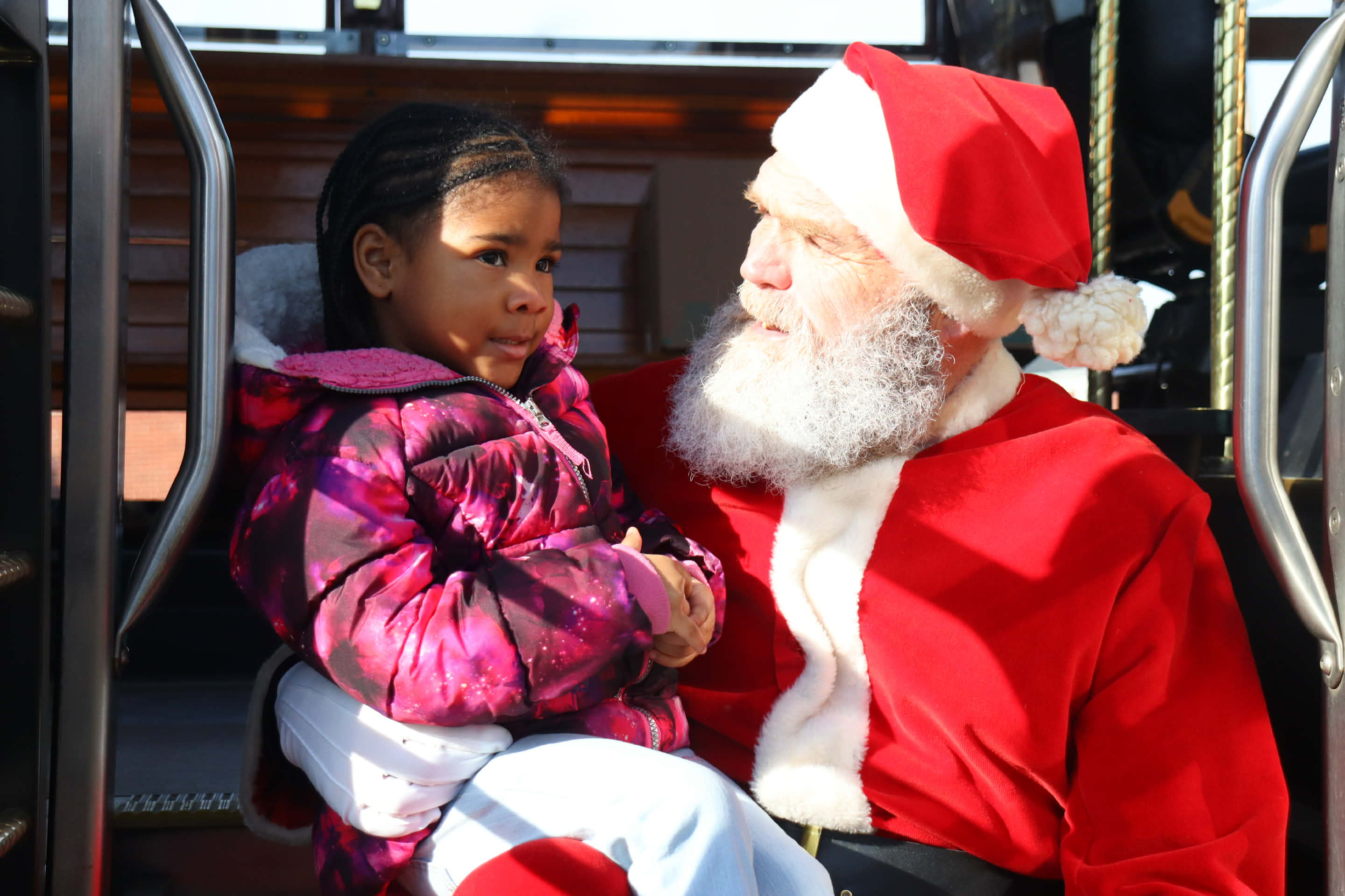 Santa Claus sits with one of the residents of Hilltop...