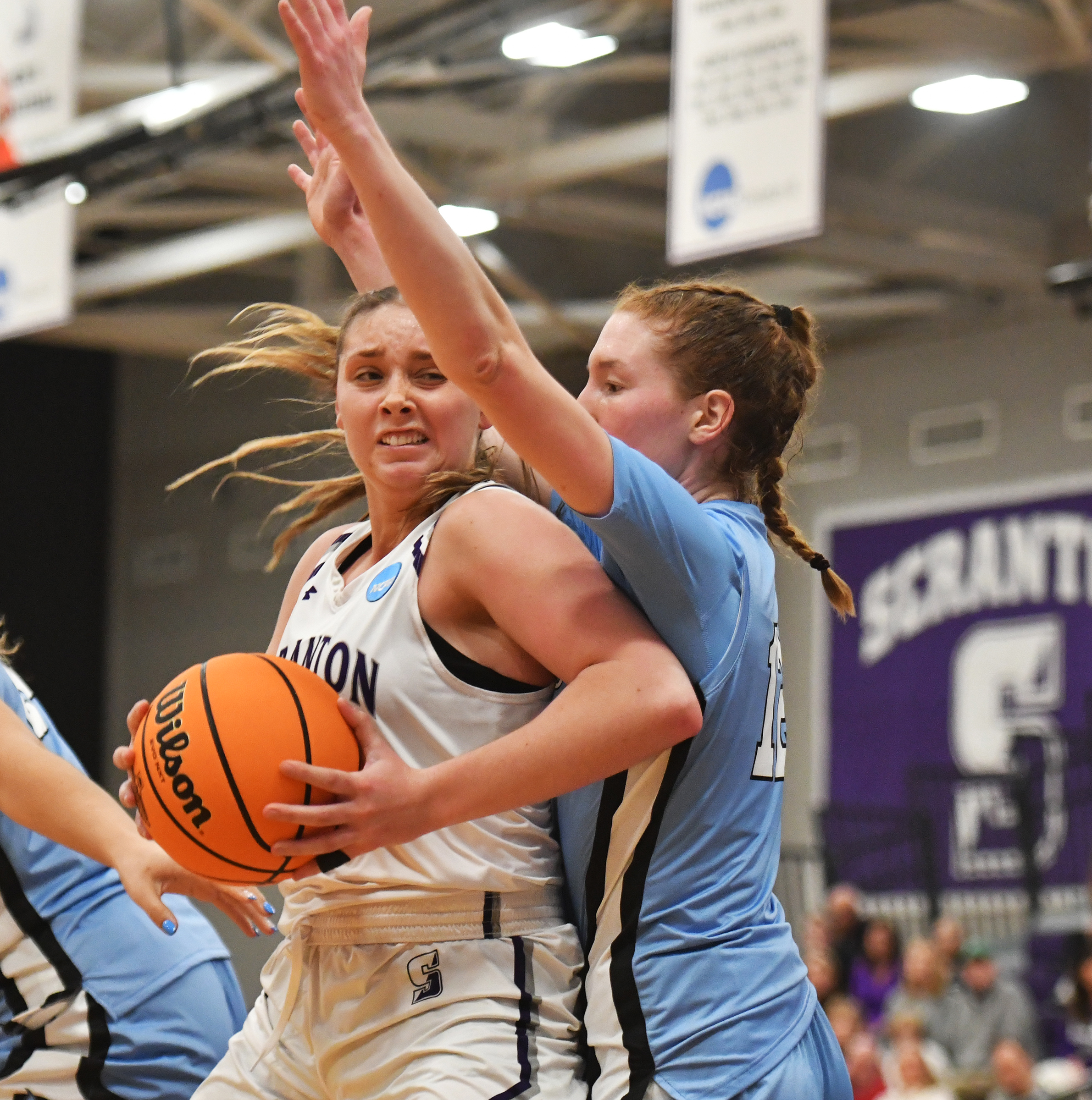 Scranton’s Kaci Kranson, left, fights through defense of Johns Hopkins’...