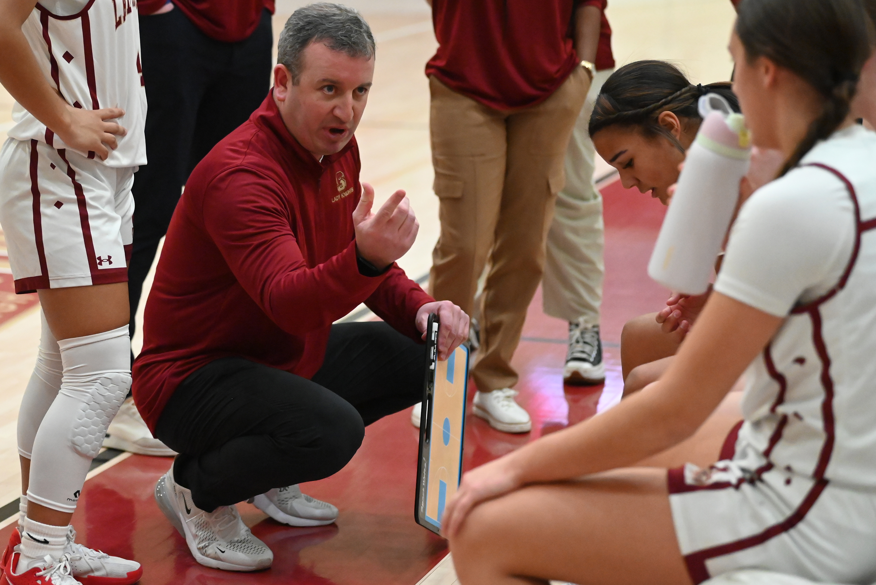 Scranton’s head coach P.J. Hughes talks to his players between...