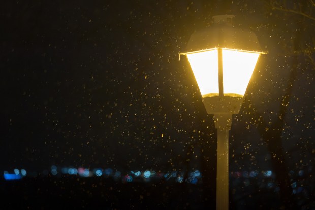 A parking lot light shines through frozen rain in Scranton on Friday, Dec. 26, 2025. (JASON ARDAN / STAFF PHOTOGRAPHER)