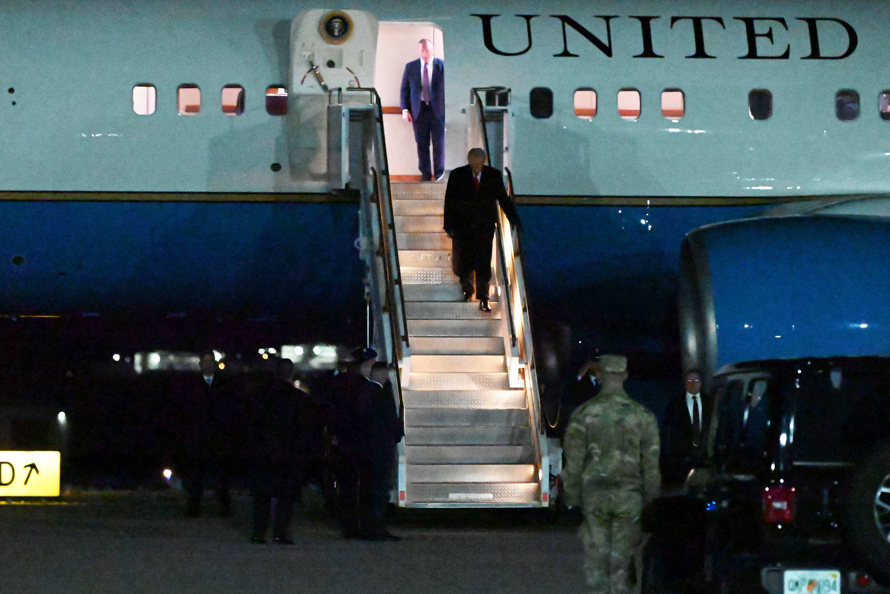 President Donald Trump disembarks from Air Force One at the...