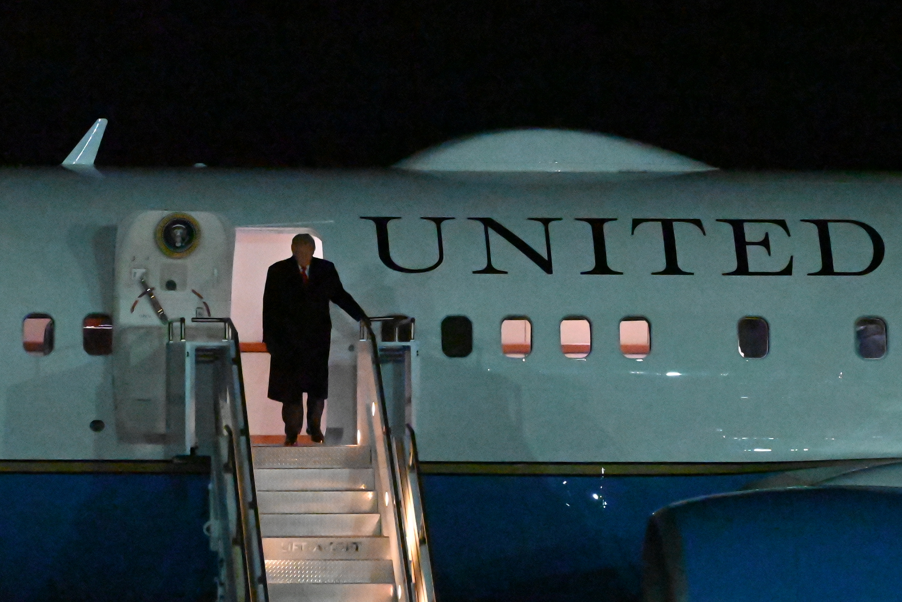 President Donald Trump disembarks from Air Force One at the...