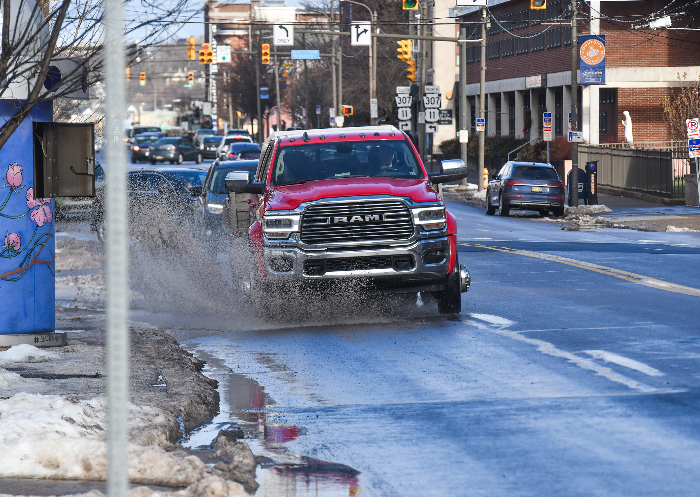 A truck drives through a puddle on Wyoming Ave. in...