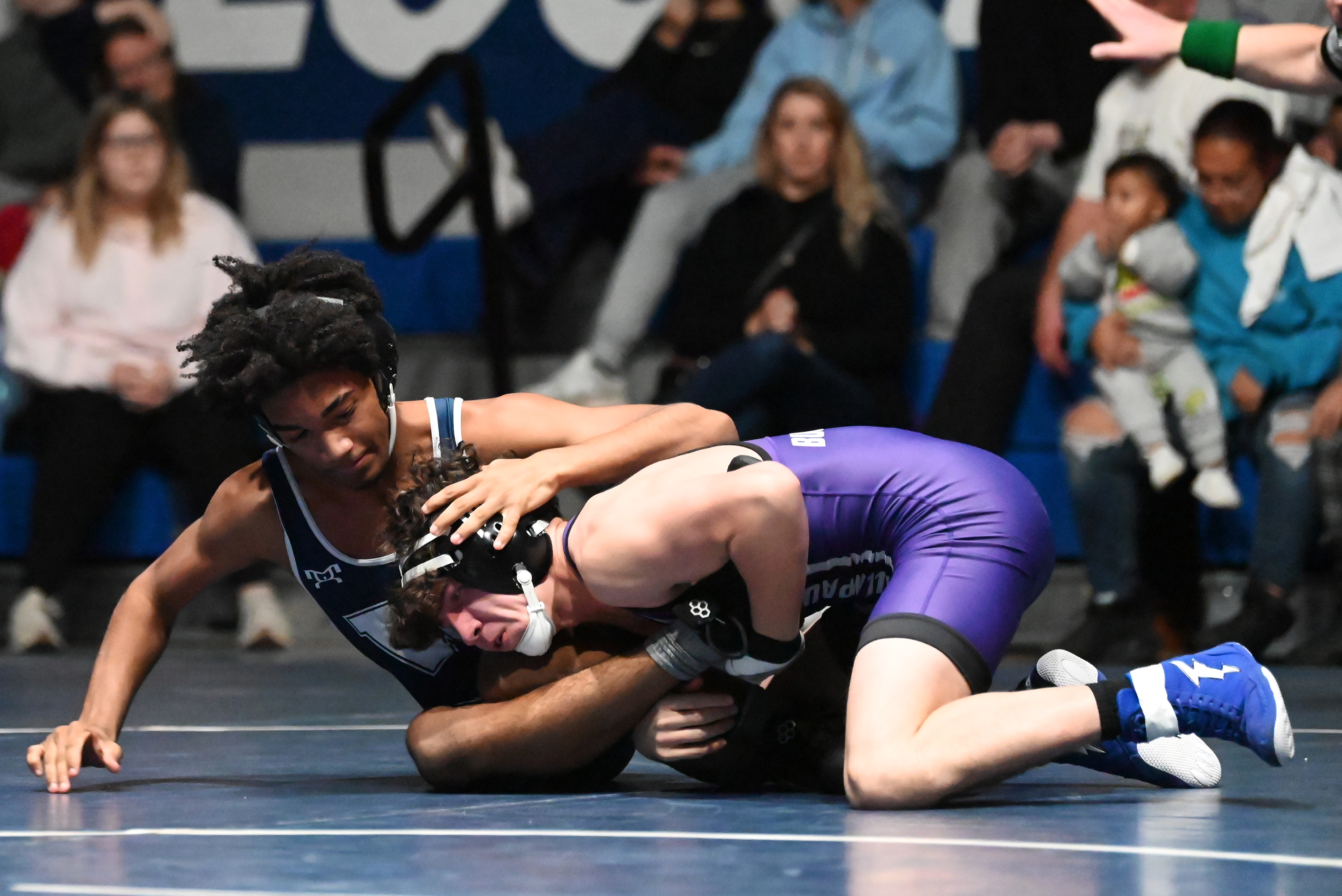 Wallenpaupack’s Kyle Scartelli, right, wrestles West Scranton’s Reggie Rollins during...