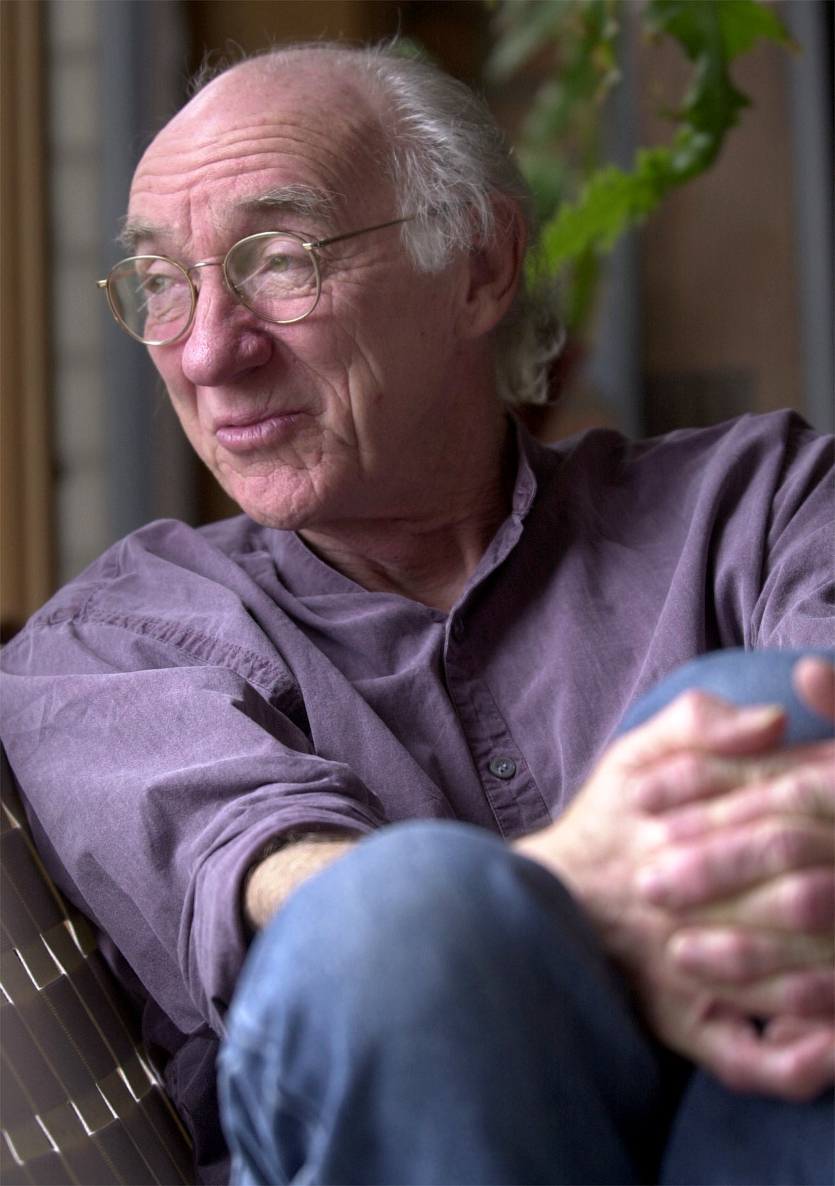 Poet Harry Humes of Lenhartsville sits in his home Friday,...