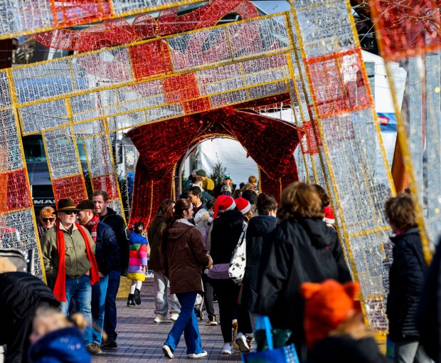 People enjoy the sights and sounds Saturday, Dec. 20, 2025, during Christkindlmarkt in Bethlehem. The German-inspired holiday market, which closes Sunday, Dec. 21, 2025, features artisan vendors, festive treats and family activities. (April Gamiz/The Morning Call)