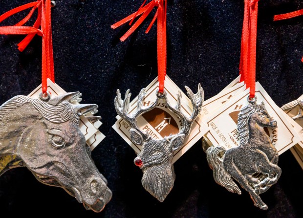 House of Morgan Pewter's ornaments shine Saturday, Dec. 20, 2025, during Christkindlmarkt in Bethlehem. The German-inspired holiday market, which closes Sunday, Dec. 21, 2025, features artisan vendors, festive treats and family activities. (April Gamiz/The Morning Call)