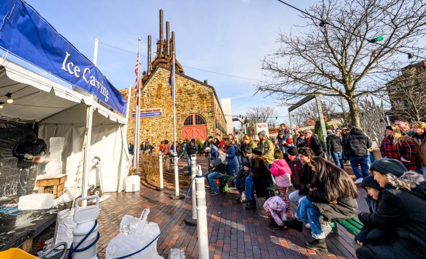 Roy Witten of Sculpted Ice Works carves an ice sculpture as people watch Saturday, Dec. 20, 2025, during Christkindlmarkt in Bethlehem. The German-inspired holiday market, which closes Sunday, Dec. 21, 2025, features artisan vendors, festive treats and family activities. (April Gamiz/The Morning Call)