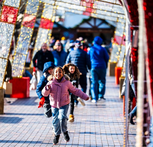 People enjoy the sights and sounds Saturday, Dec. 20, 2025, during Christkindlmarkt in Bethlehem. The German-inspired holiday market, which closes Sunday, Dec. 21, 2025, features artisan vendors, festive treats and family activities. (April Gamiz/The Morning Call)