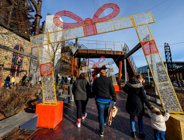 People enjoy the sights and sounds Saturday, Dec. 20, 2025, during Christkindlmarkt in Bethlehem. The German-inspired holiday market, which closes Sunday, Dec. 21, 2025, features artisan vendors, festive treats and family activities. (April Gamiz/The Morning Call)