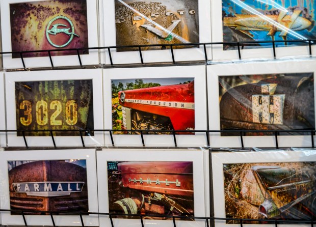 People look to buy fine art photography prints by local artist Scott Krycia inside the Handwerk Haus on Saturday, Dec. 20, 2025, during Christkindlmarkt in Bethlehem. The German-inspired holiday market, which closes Sunday, Dec. 21, 2025, features artisan vendors, festive treats and family activities. (April Gamiz/The Morning Call)