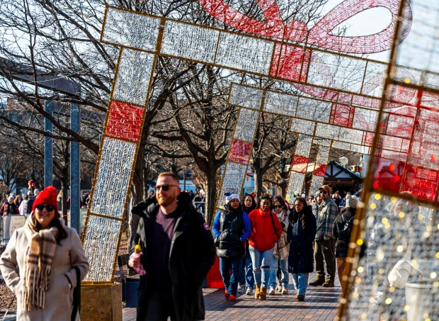 People enjoy the sights and sounds Saturday, Dec. 20, 2025, during Christkindlmarkt in Bethlehem. The German-inspired holiday market, which closes Sunday, Dec. 21, 2025, features artisan vendors, festive treats and family activities. (April Gamiz/The Morning Call)