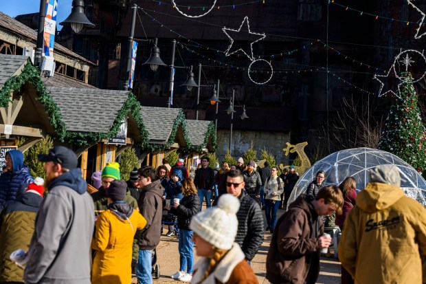 People enjoy the sights and sounds Saturday, Dec. 20, 2025, during Christkindlmarkt in Bethlehem. The German-inspired holiday market, which closes Sunday, Dec. 21, 2025, features artisan vendors, festive treats and family activities. (April Gamiz/The Morning Call)