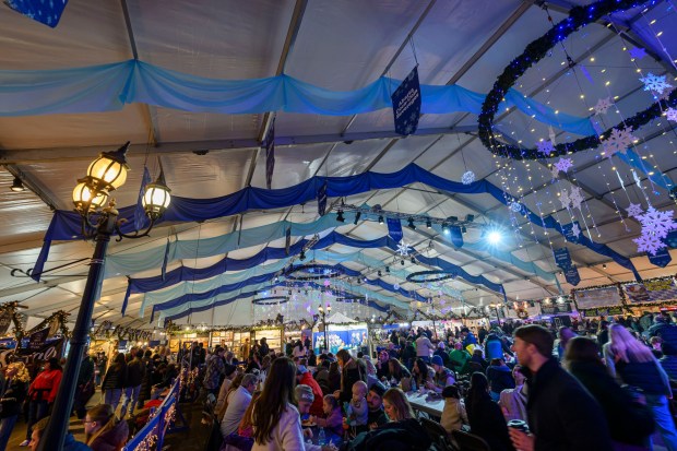 People enjoy the sights and sounds Saturday, Dec. 20, 2025, during Christkindlmarkt in Bethlehem. The German-inspired holiday market, which closes Sunday, Dec. 21, 2025, features artisan vendors, festive treats and family activities. (April Gamiz/The Morning Call)