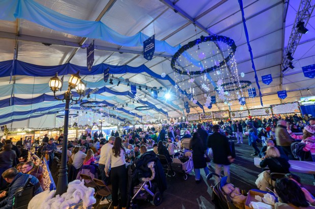 People enjoy the sights and sounds Saturday, Dec. 20, 2025, during Christkindlmarkt in Bethlehem. The German-inspired holiday market, which closes Sunday, Dec. 21, 2025, features artisan vendors, festive treats and family activities. (April Gamiz/The Morning Call)
