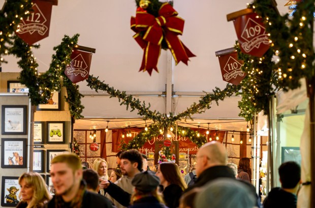 People enjoy the sights and sounds Saturday, Dec. 20, 2025, during Christkindlmarkt in Bethlehem. The German-inspired holiday market, which closes Sunday, Dec. 21, 2025, features artisan vendors, festive treats and family activities. (April Gamiz/The Morning Call)