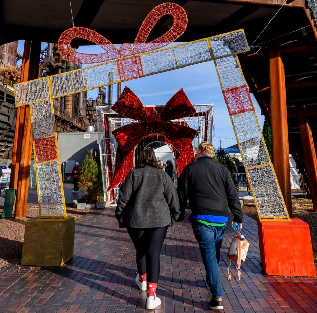 People enjoy the sights and sounds Saturday, Dec. 20, 2025, during Christkindlmarkt in Bethlehem. The German-inspired holiday market, which closes Sunday, Dec. 21, 2025, features artisan vendors, festive treats and family activities. (April Gamiz/The Morning Call)