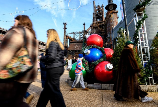 People enjoy the sights and sounds Saturday, Dec. 20, 2025, during Christkindlmarkt in Bethlehem. The German-inspired holiday market, which closes Sunday, Dec. 21, 2025, features artisan vendors, festive treats and family activities. (April Gamiz/The Morning Call)