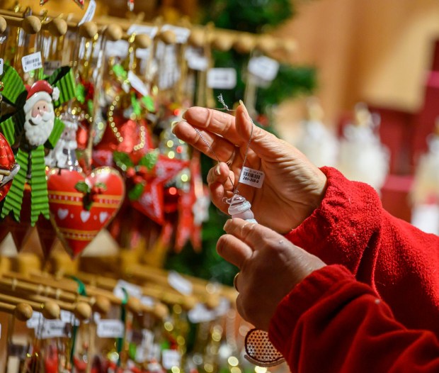 Käthe Wohlfahrt's glass ornaments seem to glow in the light Saturday, Dec. 20, 2025, during Christkindlmarkt in Bethlehem. The German-inspired holiday market, which closes Sunday, Dec. 21, 2025, features artisan vendors, festive treats and family activities. (April Gamiz/The Morning Call)