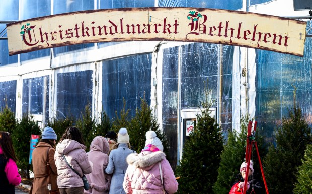 People enjoy the sights and sounds Saturday, Dec. 20, 2025, during Christkindlmarkt in Bethlehem. The German-inspired holiday market, which closes Sunday, Dec. 21, 2025, features artisan vendors, festive treats and family activities. (April Gamiz/The Morning Call)