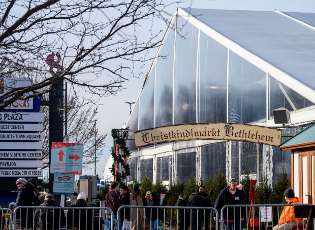 People enjoy the sights and sounds Saturday, Dec. 20, 2025, during Christkindlmarkt in Bethlehem. The German-inspired holiday market, which closes Sunday, Dec. 21, 2025, features artisan vendors, festive treats and family activities. (April Gamiz/The Morning Call)