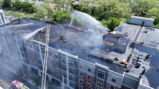 The roof of the Five 10 Flats apartment complex at 510 E. Third St. in south Bethlehem is heavily damaged by fire Friday, May 2, 2025. (Rich Rolen/Special to The Morning Call)