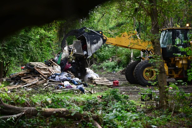 City trucks collect and dispose of pallets, tarps and other personal belongings Monday, Sept. 29, 2025, at the Jordan Creek homeless encampment in Allentown during a sweep by city officials to clear residents out of the site. While many residents were able to grab their belongings, others said they lost a lot because they didn't have help. Allentown officials announced in early Aug. that the camp would be cleared, citing flooding concerns. After an initial deadline of Aug. 25, Allentown Mayor Matt Tuerk extended the evacuation date to Monday to coincide with the opening of the Allentown YMCA's warming station. Despite the advance warning, however, some of the residents stayed up until the last possible moment, saying they had nowhere else to go. (Monica Cabrera/The Morning Call)