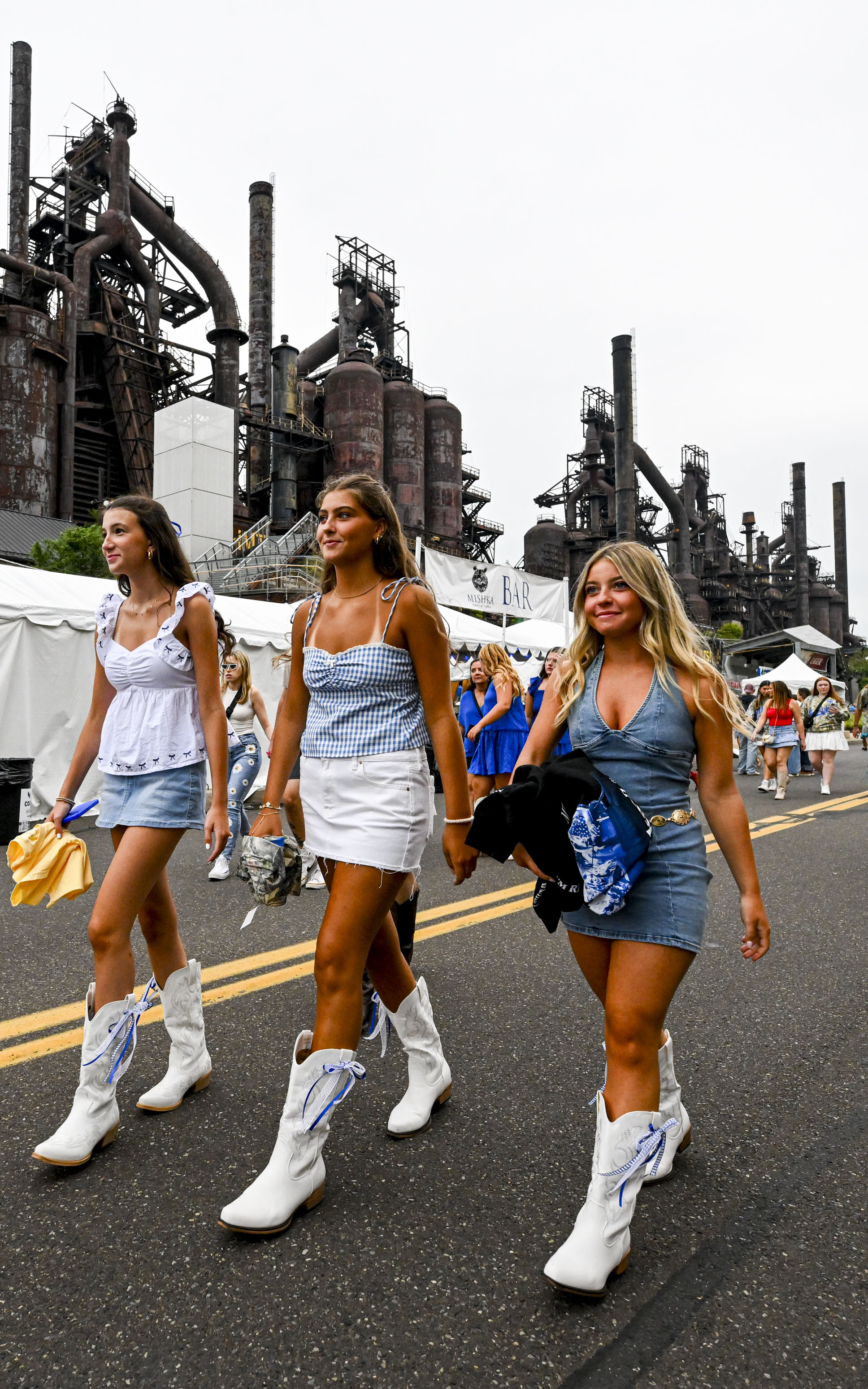 Julie Kellie, Camilla Stella and Lucy Bergen, all of Wilmington, Delaware walk around before attending Megan Moroney's concert Thursday, July 31, 2025, during Musikfest's preview night in Bethlehem.(April Gamiz/The Morning Call)