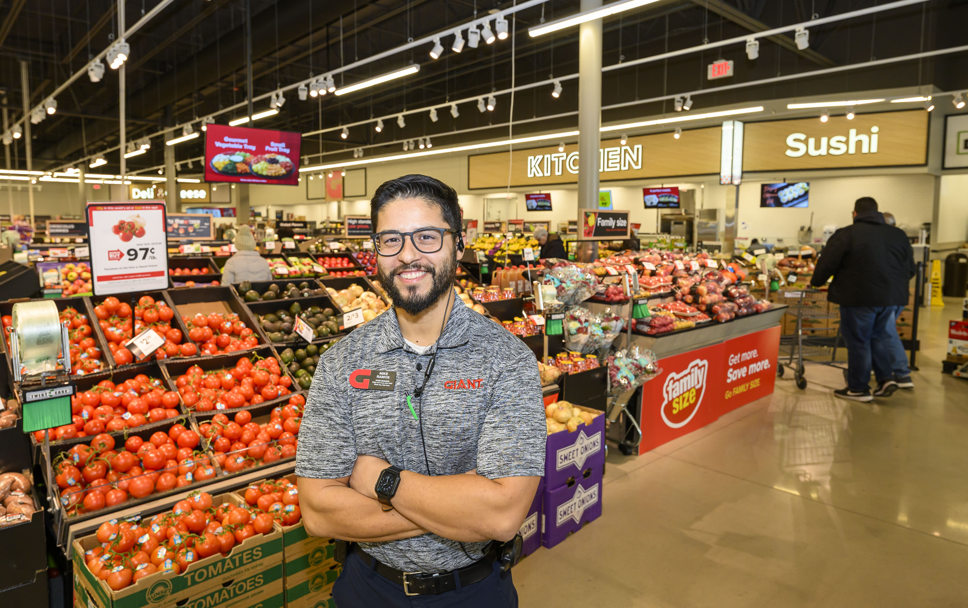 Giant store manager Mike Ramos stands in the produce section...