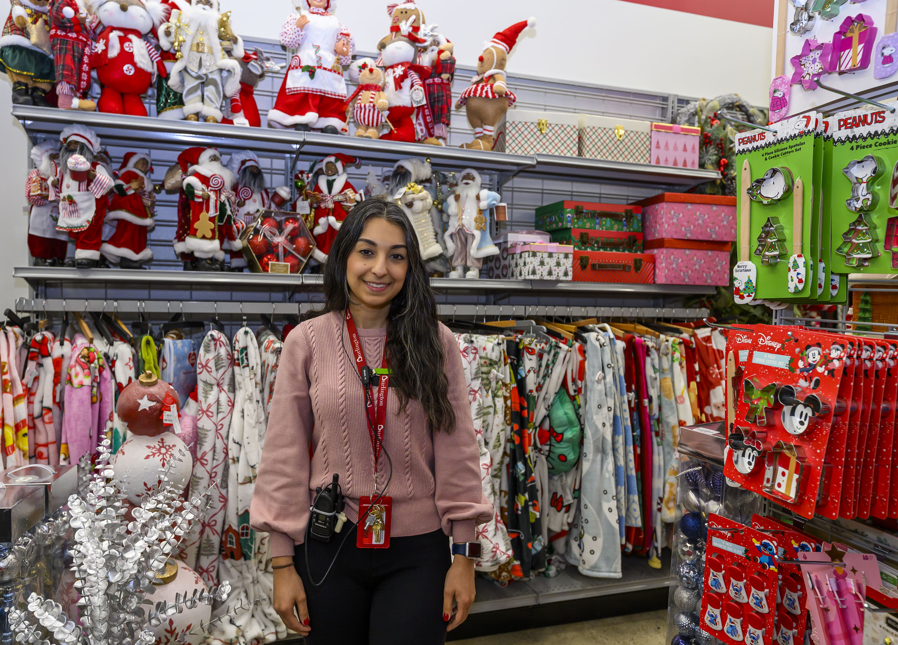 Burlington store manager Mary Kreit stands near popular holiday decor...