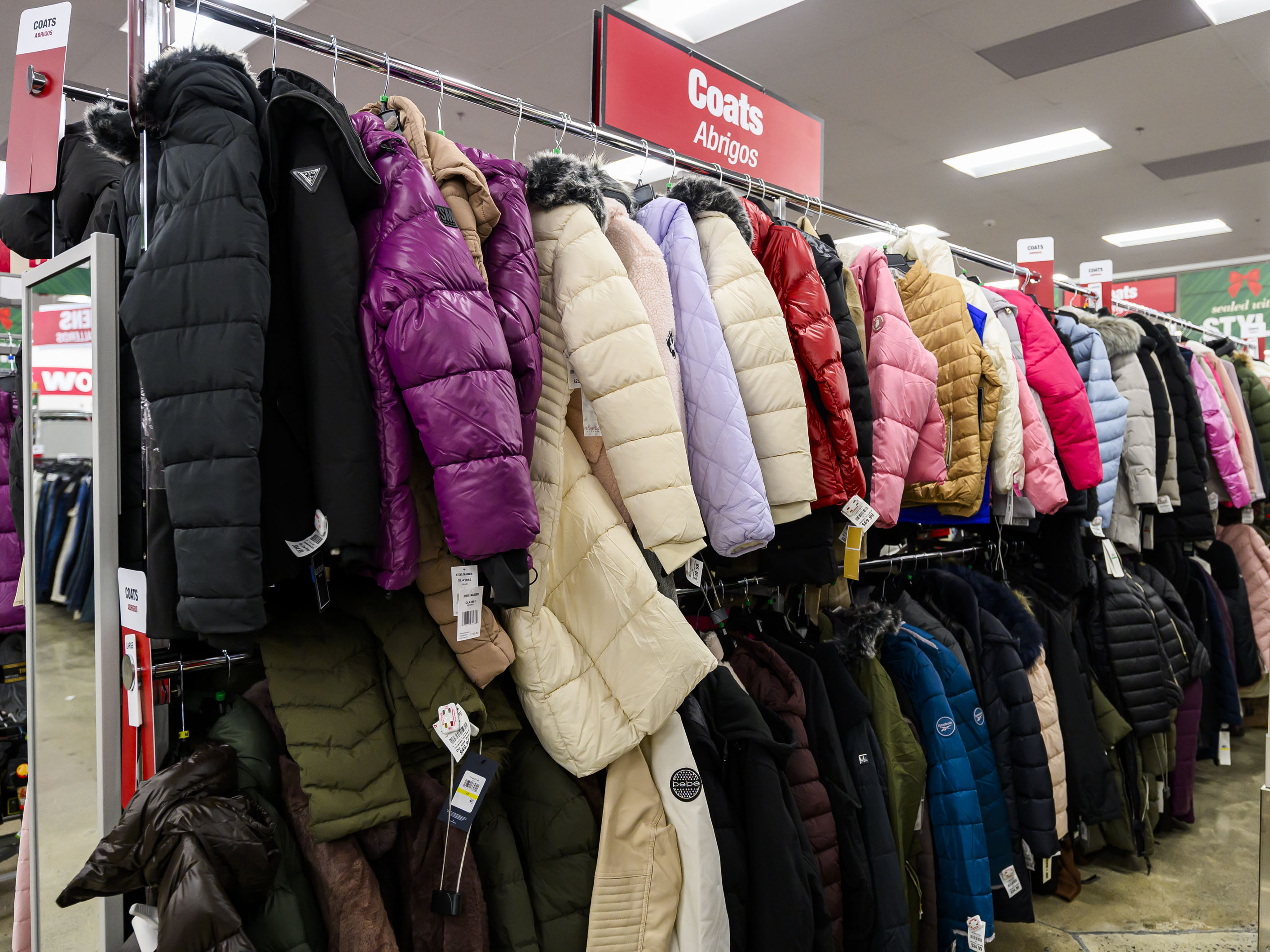 Coats line aisles Tuesday, Dec. 9, 2025, at the newly...