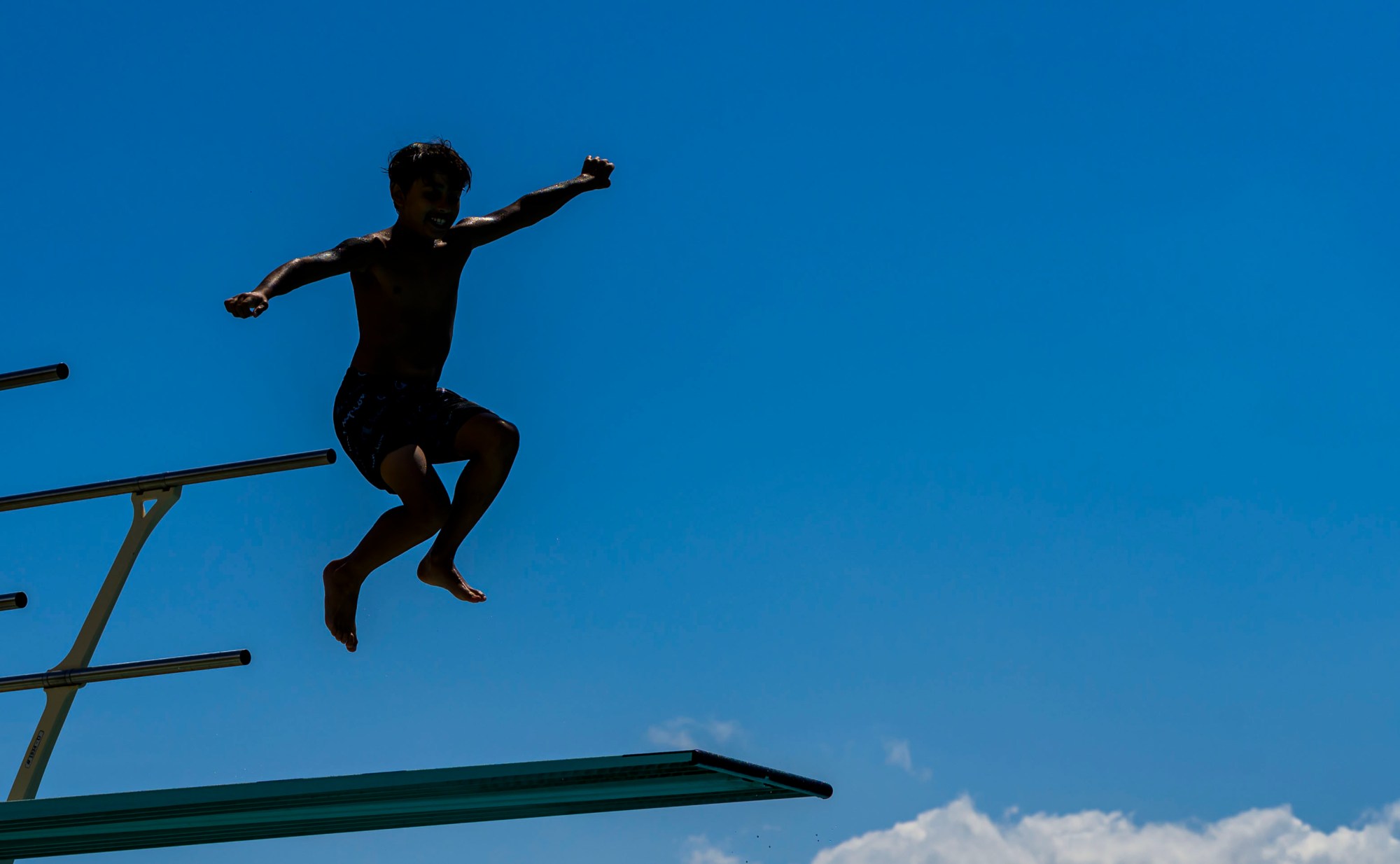 Cartor Diaz, 10, of Bethlehem uses a diving board Thursday, June 19, 2025, at Memorial Pool in Bethlehem. The crowds tried to stay cool in the hot and humid weather, with the heat index in the 90s, on the last day of spring. (April Gamiz/The Morning Call)