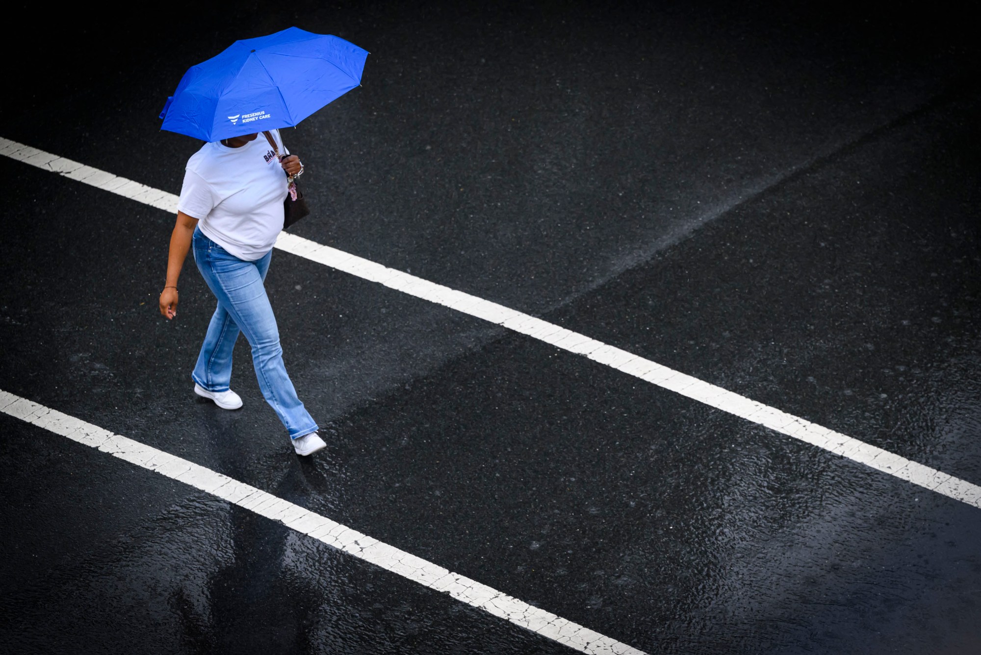 A person uses an umbrella to shield them from drenching rains Friday, May 16, 2025, in Bethlehem. A line of severe storms moving across eastern Pennsylvania prompted the National Weather Service to issue a severe thunderstorm warning for the Lehigh Valley and surrounding region Friday morning. There is a possibility of more storms Saturday. (April Gamiz/The Morning Call)