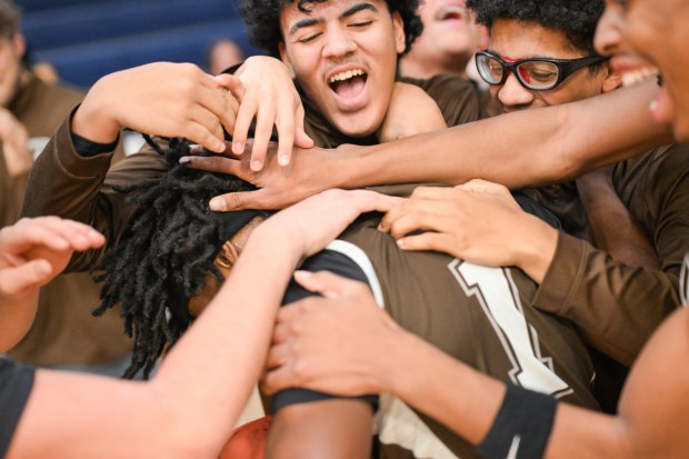Catasauqua's team members mob Frankie Pujols to celebrate him scoring his 1,000th career point while playing against Pleasant Valley during a Slatington Rotary tournament game at Northern Lehigh High School. (Jonathan Broady/Special to The Morning Call)