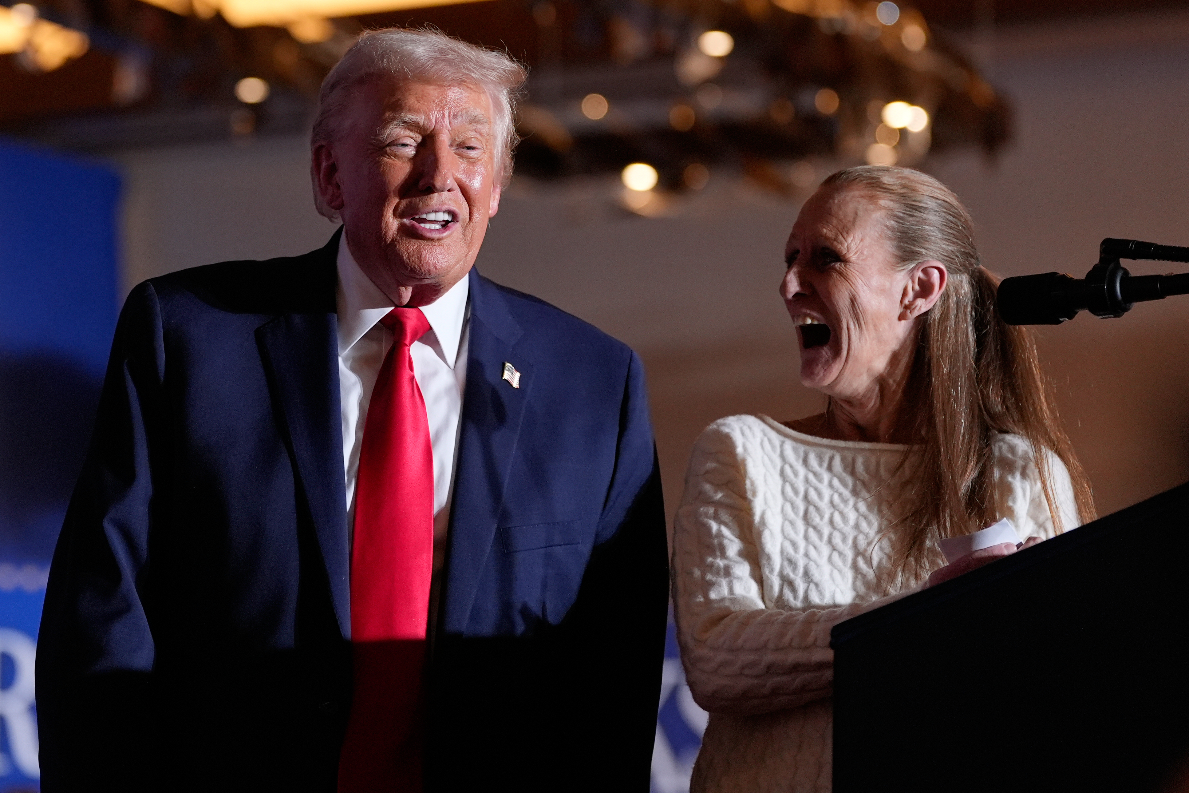 President Donald Trump smiles as Donna Zajack speaks at Mount...