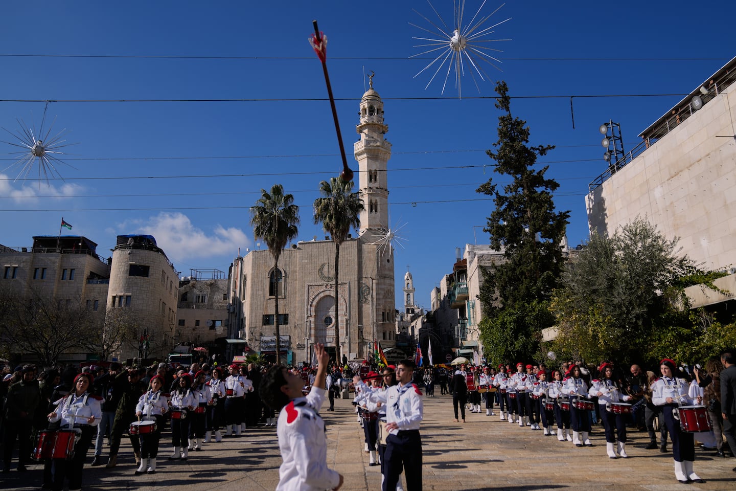 Palestinian scout bands parade at the Manger Square near the Church of the Nativity, traditionally believed to be the birthplace of Jesus, on Christmas Eve, in the West Bank city of Bethlehem.