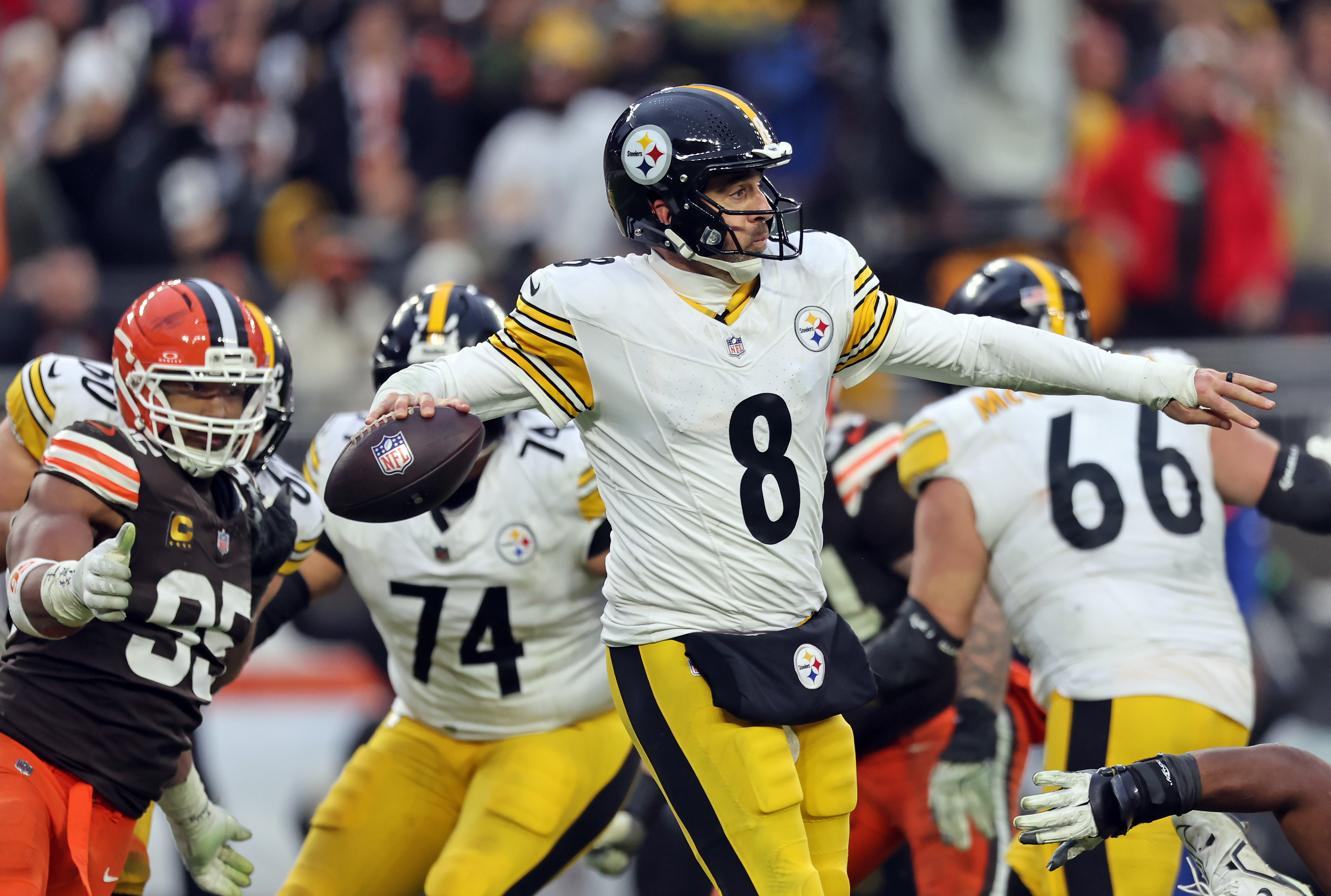 Pittsburgh Steelers quarterback Aaron Rodgers throws as Cleveland Browns defensive end Myles Garrett pressures in the second half of play. 