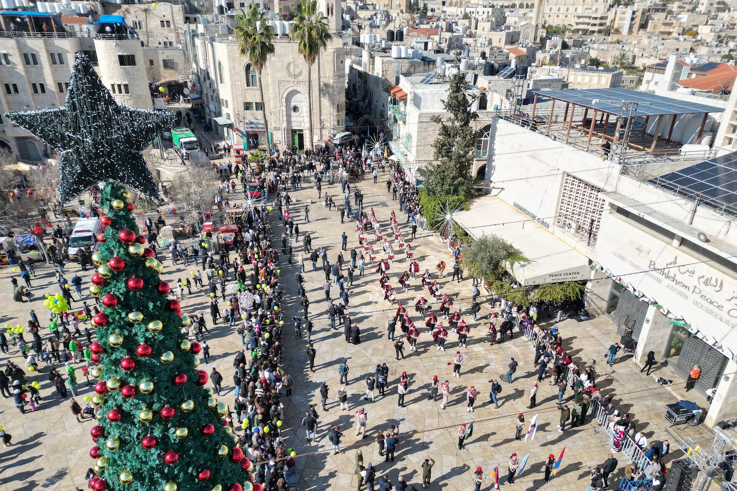 An aerial view shows scouts marching during Christmas eve celebrations on Manger Square outside the Church of the Nativity (unseen) in Bethlehem, in the Israeli-occupied West Bank.