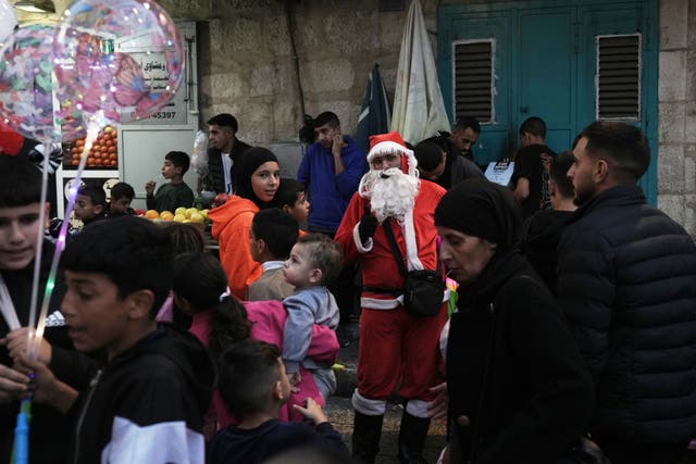 Man dressed as Father Christmas in crowd