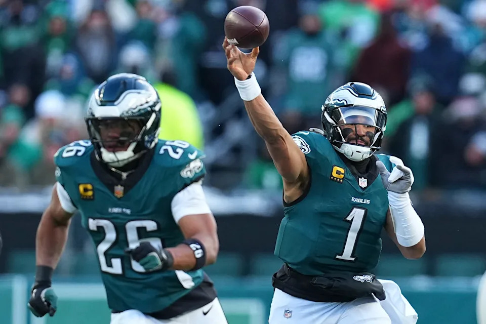 PHILADELPHIA, PENNSYLVANIA - DECEMBER 14: Jalen Hurts #1 of the Philadelphia Eagles passes the ball as Saquon Barkley #26 looks on against the Las Vegas Raiders at Lincoln Financial Field on December 14, 2025 in Philadelphia, United States. (Photo by Mitchell Leff/Getty Images)