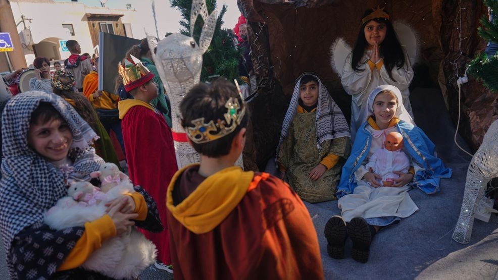 Wearing traditional costumes, children take part in the 40th annual Christmas parade heading towards the Basilica of the Annunciation in Nazareth, Israel, Wednesday, Dec. 24, 2025. (AP Photo/Ariel Schalit)