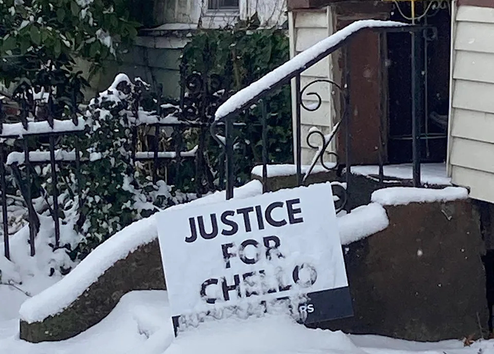 A sign in support of homicide victim Marchello Woodard is posted in a yard on East Second Street, near German Street in Erie.